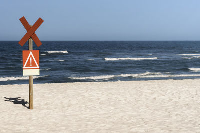 Lifeguard hut on beach against clear sky