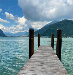 Wooden pier over sea against sky