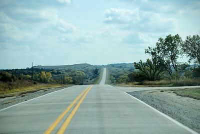 Empty country road along trees