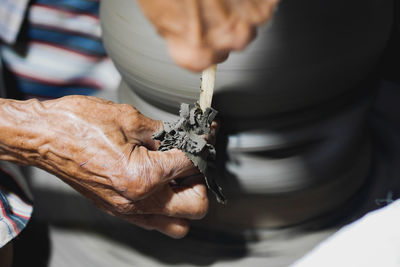 Close-up of man making pottery