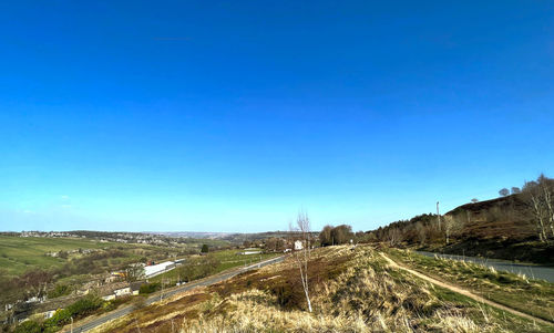 Panoramic view of haworth townscape against a clear blue sky in yorkshire, uk