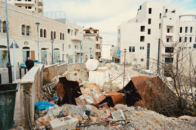 Garbage in building against sky in city