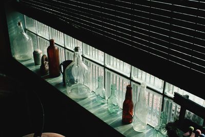 Close-up of bottle on table by window