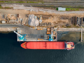 Port cranes load various cargoes or building materials into the hold of the ship. 