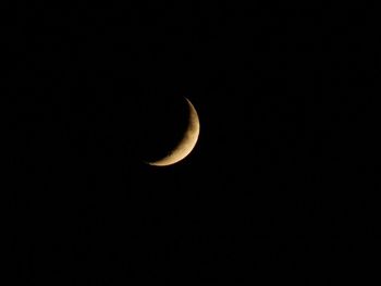 Low angle view of half moon against sky at night