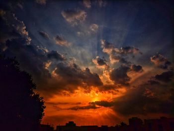Low angle view of silhouette buildings against sky during sunset