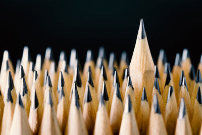 Close-up of colored pencils against black background