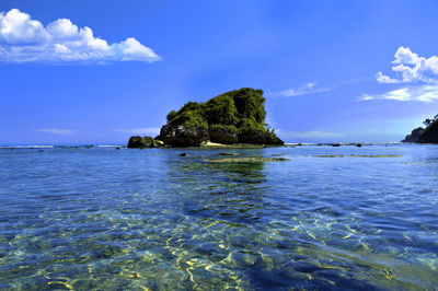 Scenic view of sea against blue sky