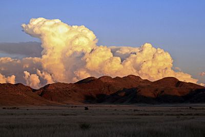 Scenic view of desert against huge cloudscape