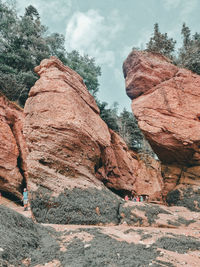 Low angle view of rocks on mountain against sky