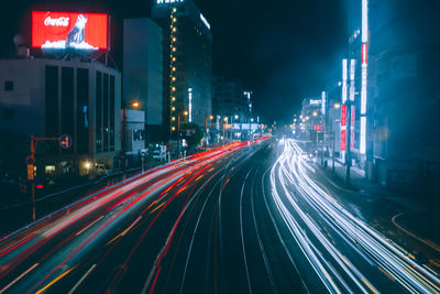 Light trails on road in city at night