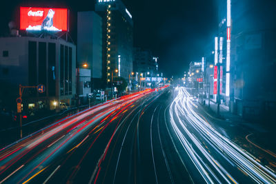 Light trails on road in city at night