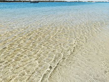 High angle view of sea on shore at beach during sunny day