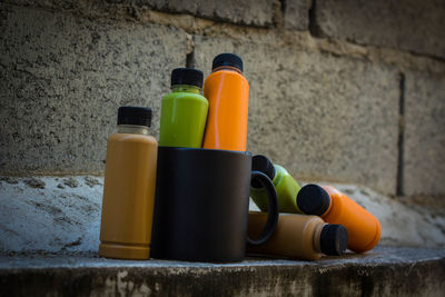 Close-up of multi colored bottles on wall