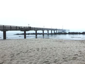 Pier over sea against clear sky