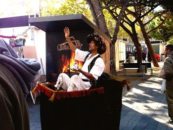 Rear view of people sitting on street