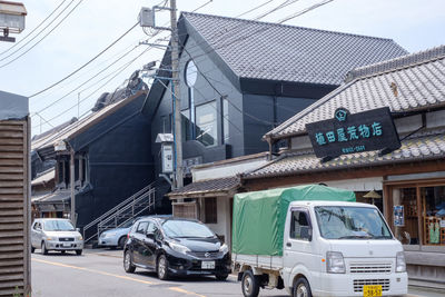 Vehicles on road against buildings in city