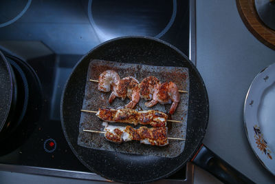 High angle view of meat on barbecue grill at home