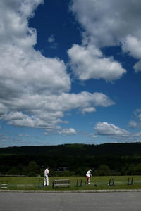 People standing on landscape against sky
