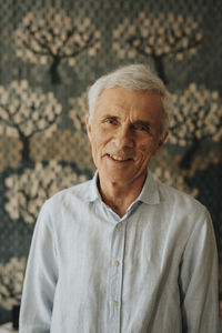 Portrait of smiling senior man at home