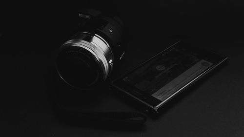 Close-up of camera phone against black background