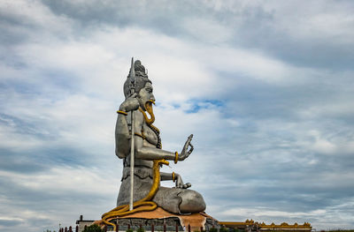 Low angle view of statue against sky