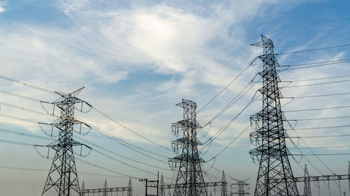 Low angle view of electricity pylon against sky