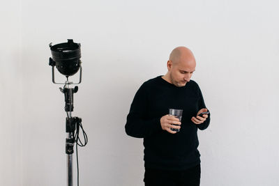 Man using mobile phone against white background