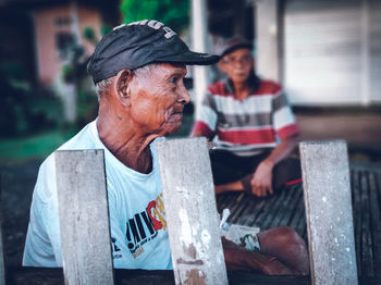 Portrait of people sitting outdoors