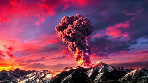 Scenic view of  volcanic mountains against sky during sunset