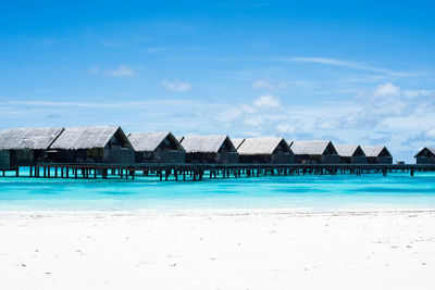 Scenic view of beach against cloudy sky