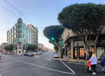 City street and buildings against clear sky