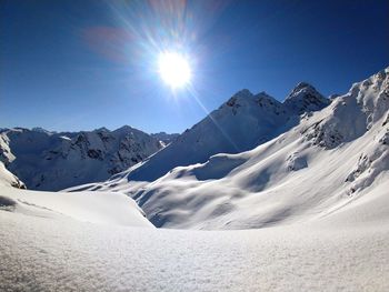 Scenic view of snowcapped mountains against sky