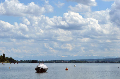 Boats sailing in river against sky