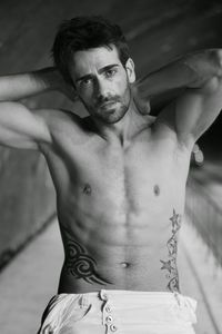 Portrait of shirtless man standing at home