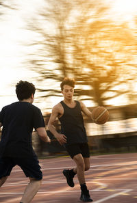 Portrait of teenage boys playing basketball