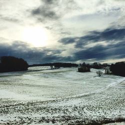 Scenic view of beach against sky during winter