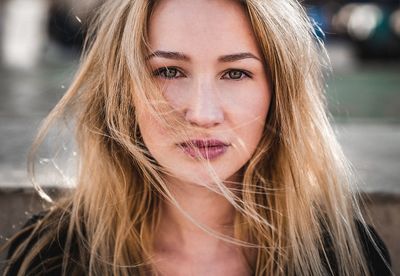 Close-up portrait of beautiful woman with tousled hair