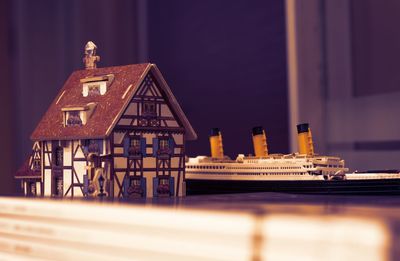 Close-up of model house and toy ship on table