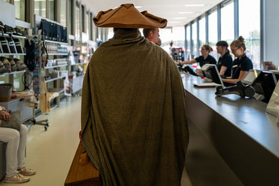 Rear view of people standing on table