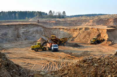 Panoramic view of vehicles on dirt road