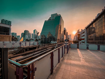Panoramic view of street and buildings against sky during sunset