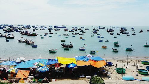 High angle view of boats moored on beach against sky