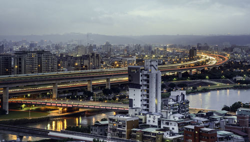 High angle view of bridge over river and buildings in city