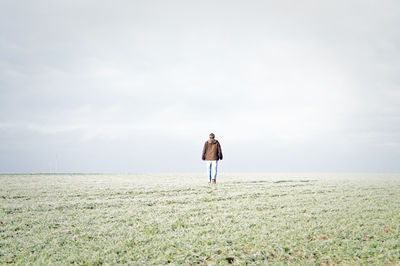 Rear view of woman standing on landscape