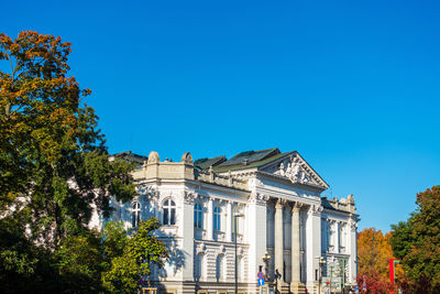 Low angle view of building against clear blue sky