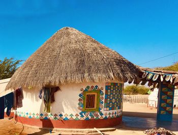 Built structure on beach against clear blue sky