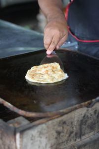 Midsection of person preparing food