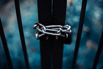 Close-up of padlock on metal grate