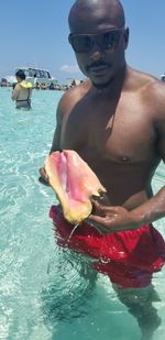 Man holding ice cream in swimming pool
